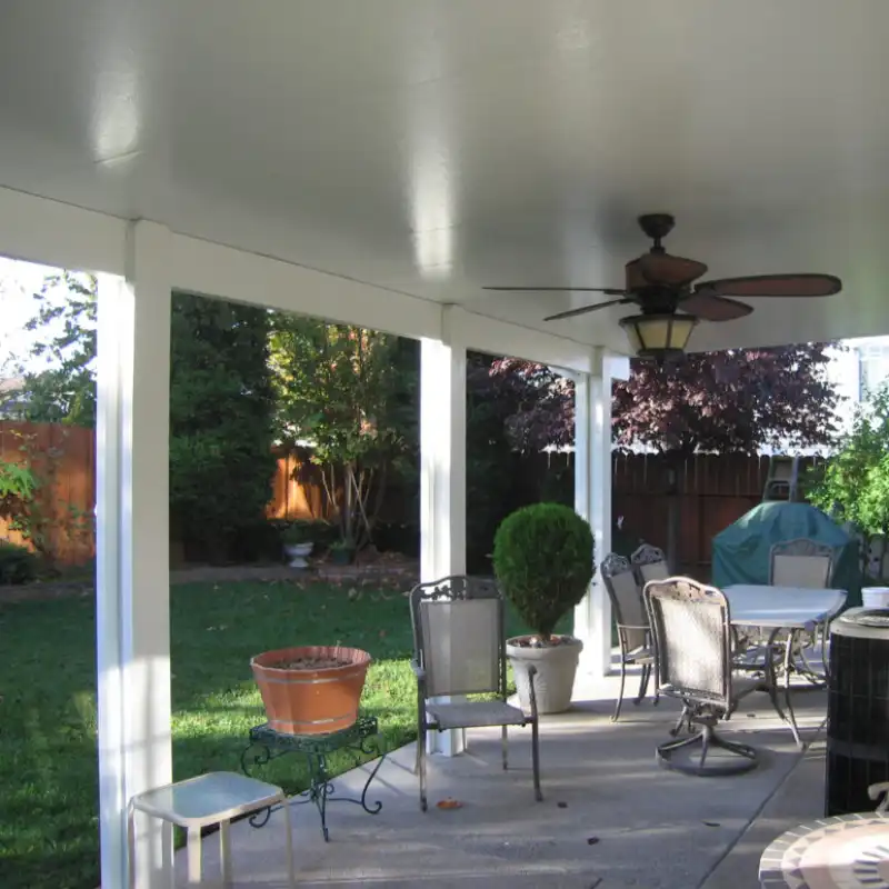 insulated roof patio cover with ceiling fan mounted on it