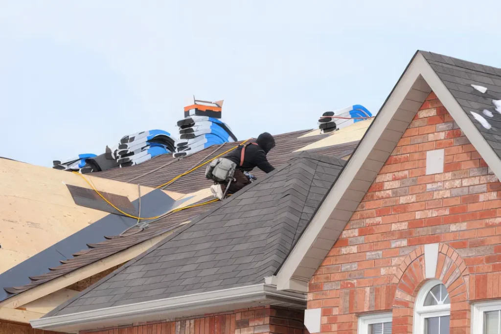 roofer on a house in louisiana installing shingles for winter roof maintenance